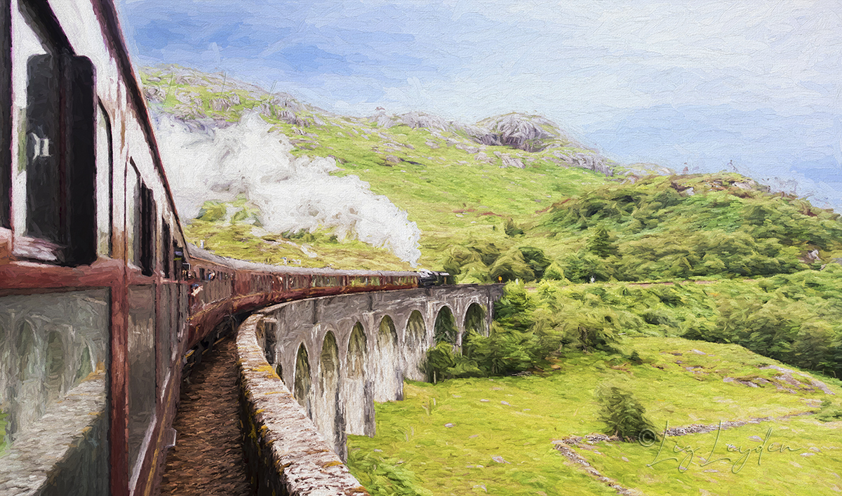 Steam train going over viaduct